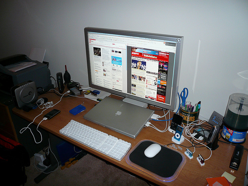Desktop workspace with a monitor, keyboard, and speakers