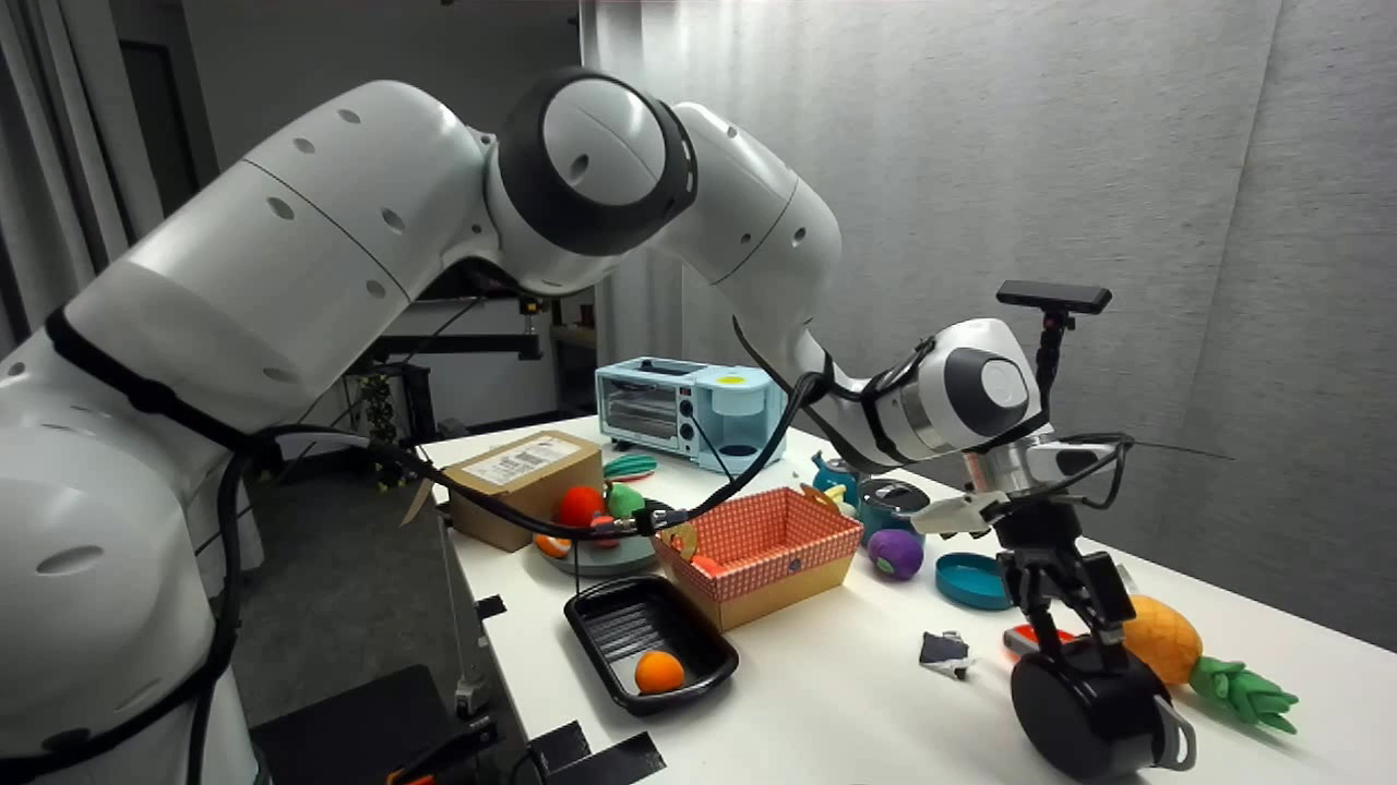 Robot arm manipulating objects on a tabletop